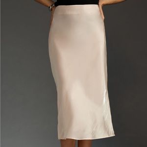 Anthropologie slip skirt in color chai. It appears like a shimmery nude.